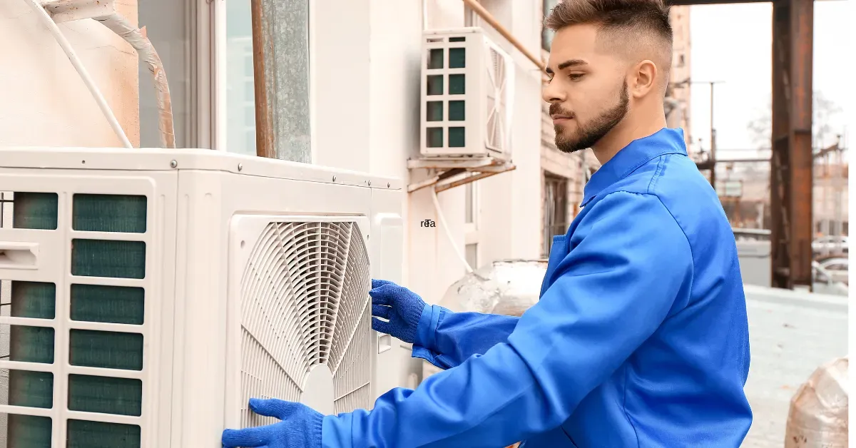 Rapid Response AC technician in a blue uniform, inspecting and servicing an outdoor air conditioning unit