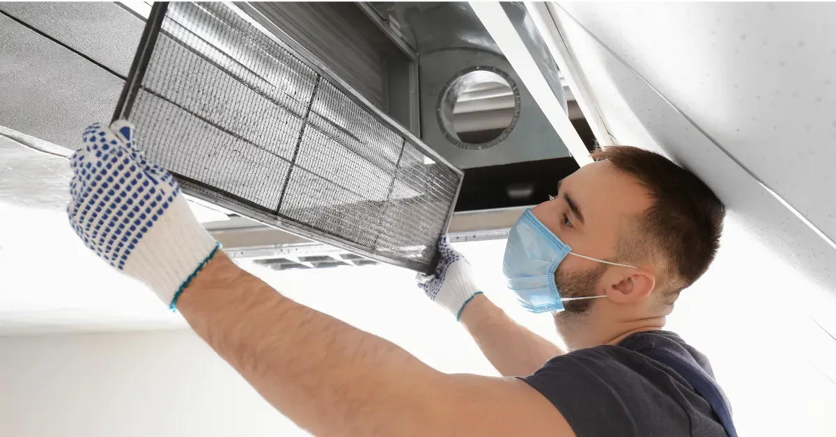 Air system maintenance specialist removing a clogged ventilation filter to restore airflow and indoor air quality